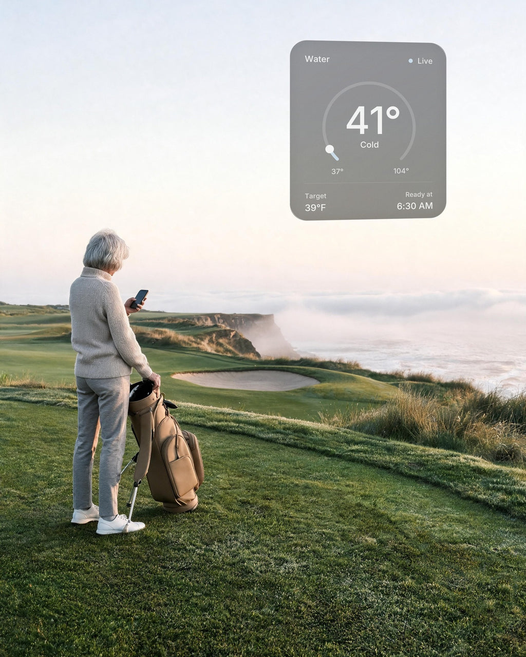 A woman on a links course above the Oregon coast at dawn checks the water of her hot and cold vessel at home on her phone: 41°F, ready at 6:30 AM