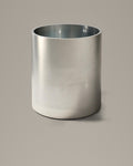 Brushed stainless steel cylindrical bathing vessel on a warm grey studio backdrop