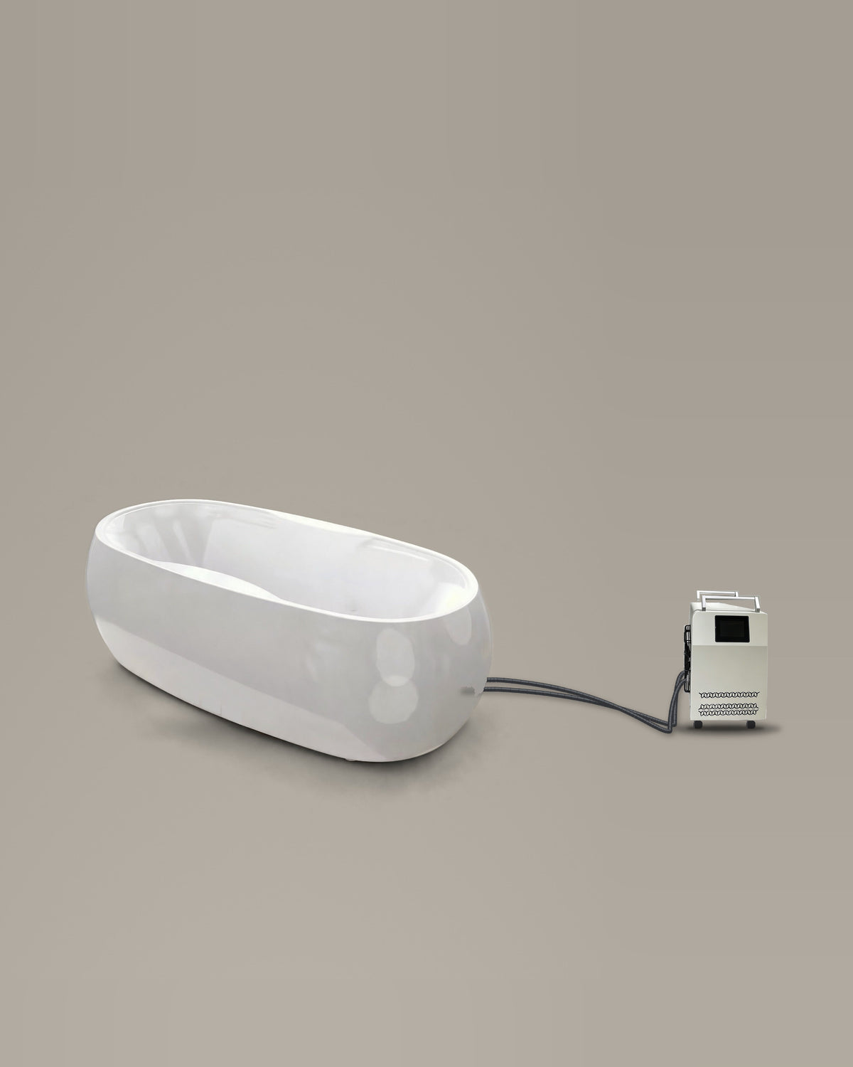 White oval bathing vessel on a warm grey studio backdrop beside its Hot & Cold Unit, connected by two braided hoses