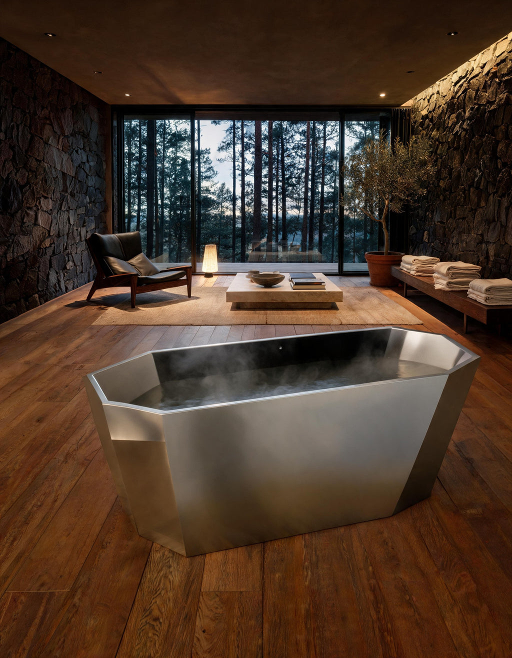 FACET octagonal vessel in Satin Steel set warm in a dark stone hall, steam rising