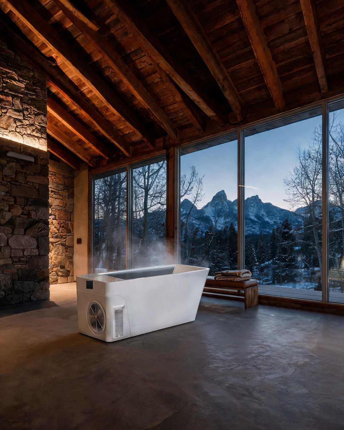 MONOLITH vessel, steam rising, in a stone and timber room facing snowy peaks at dusk