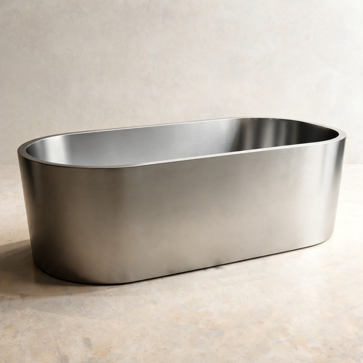 OBLONG hot and cold vessel, an oval in Satin Steel, on a pale stone floor