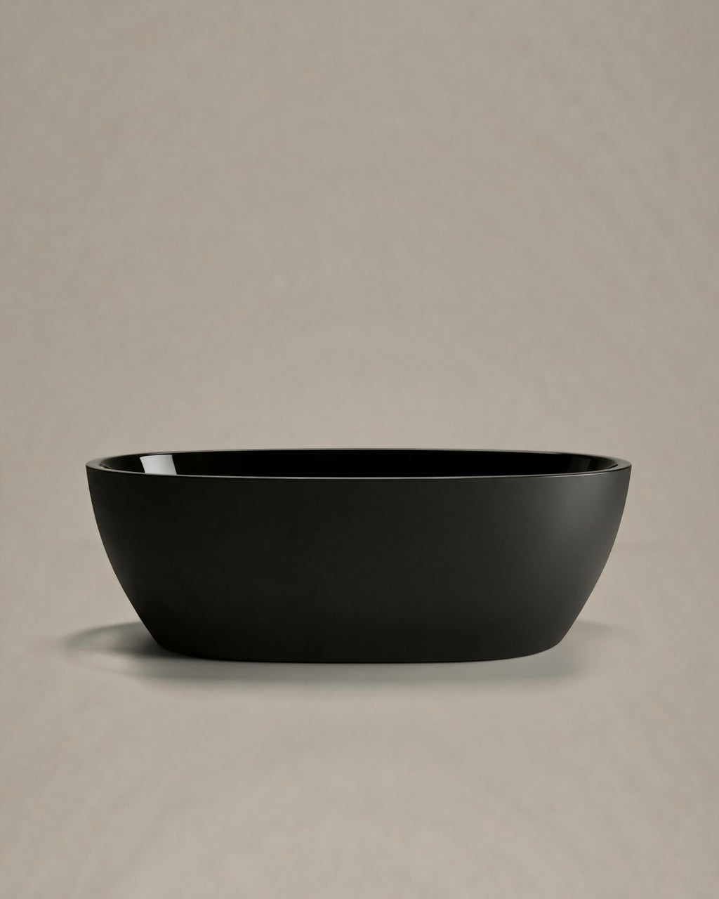 OVUM black egg-shaped vessel, side view on a warm grey studio background