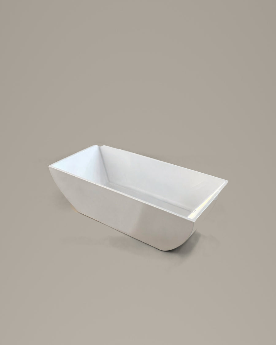 PRISM faceted vessel in white acrylic, three-quarter view, on a warm grey studio background