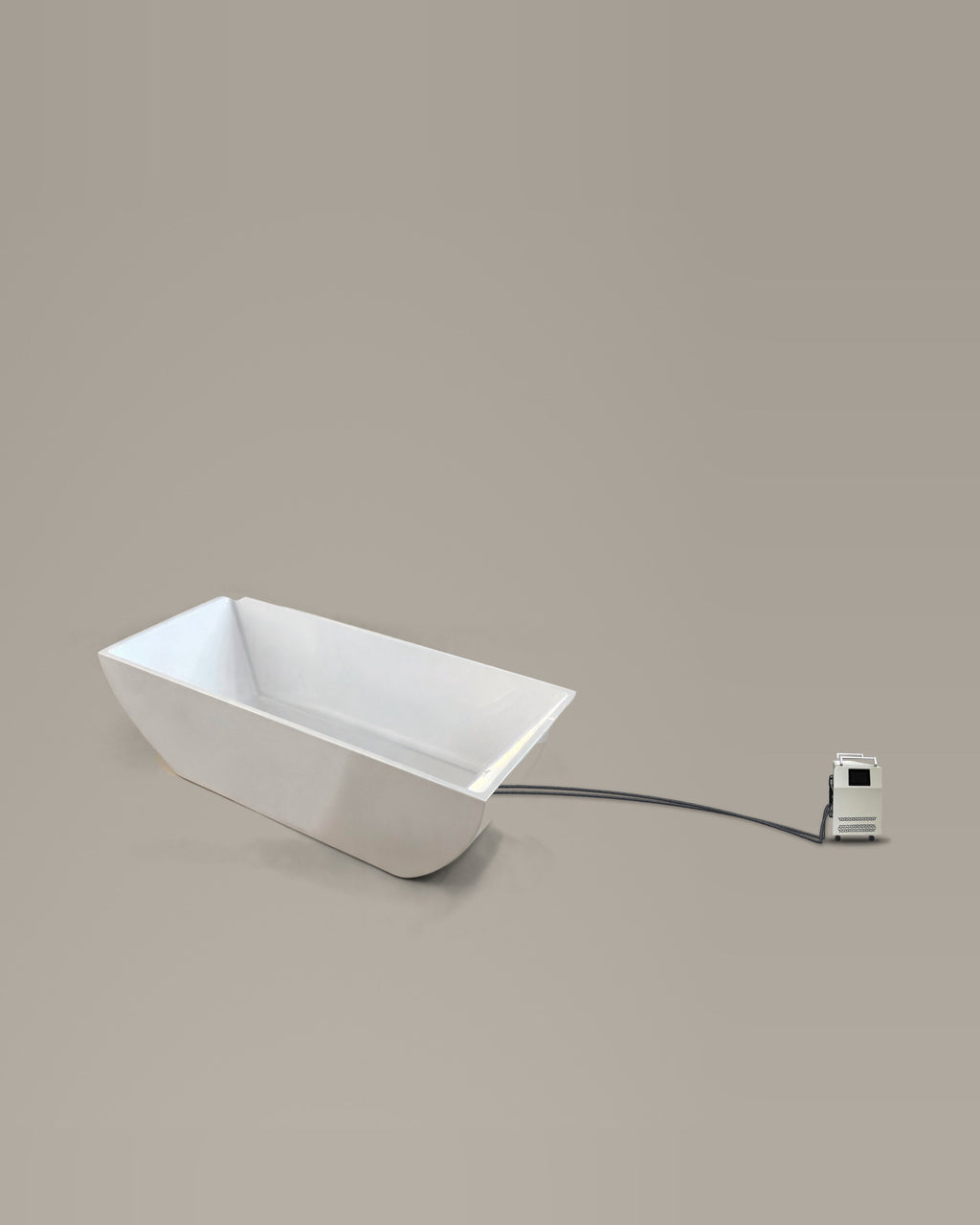 White faceted bathing vessel on a warm grey studio backdrop beside its Hot & Cold Unit, connected by two braided hoses