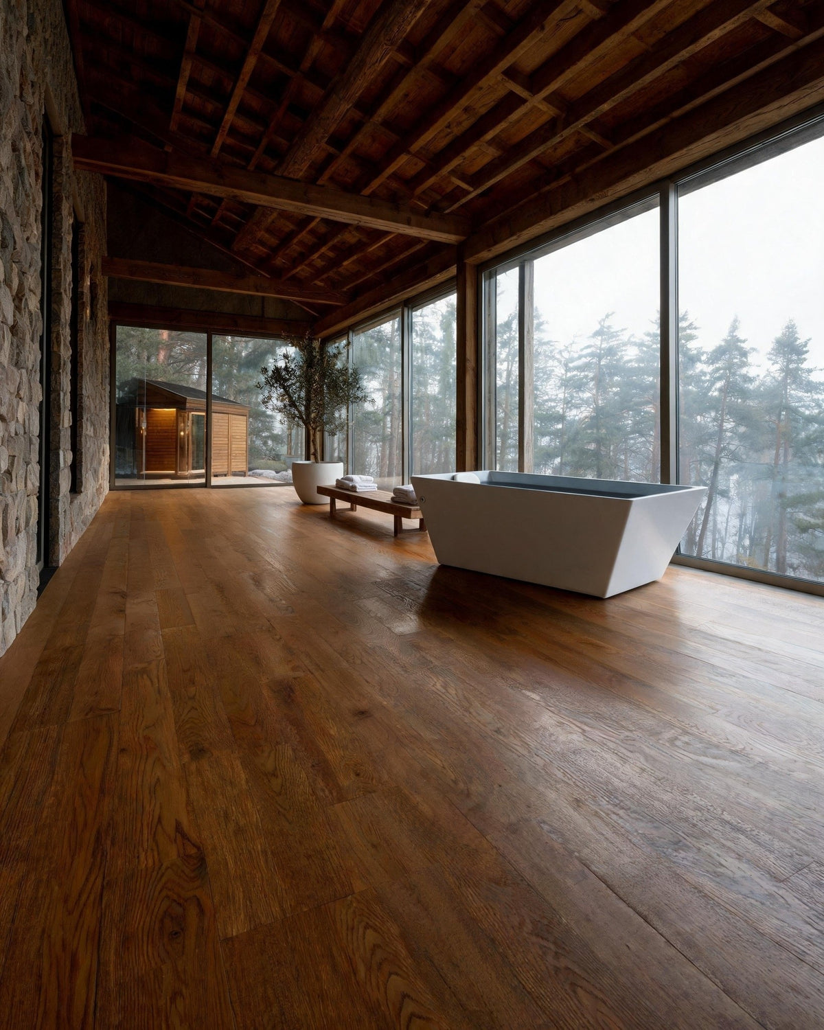 TIDE vessel filled with cold water in a stone and oak gallery facing a misty forest, a sauna beyond