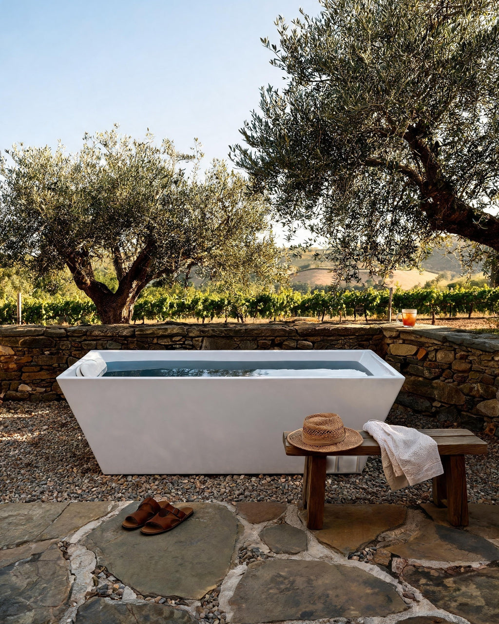 TIDE vessel filled with cold water in a stone courtyard among olive trees and vineyards in Napa Valley