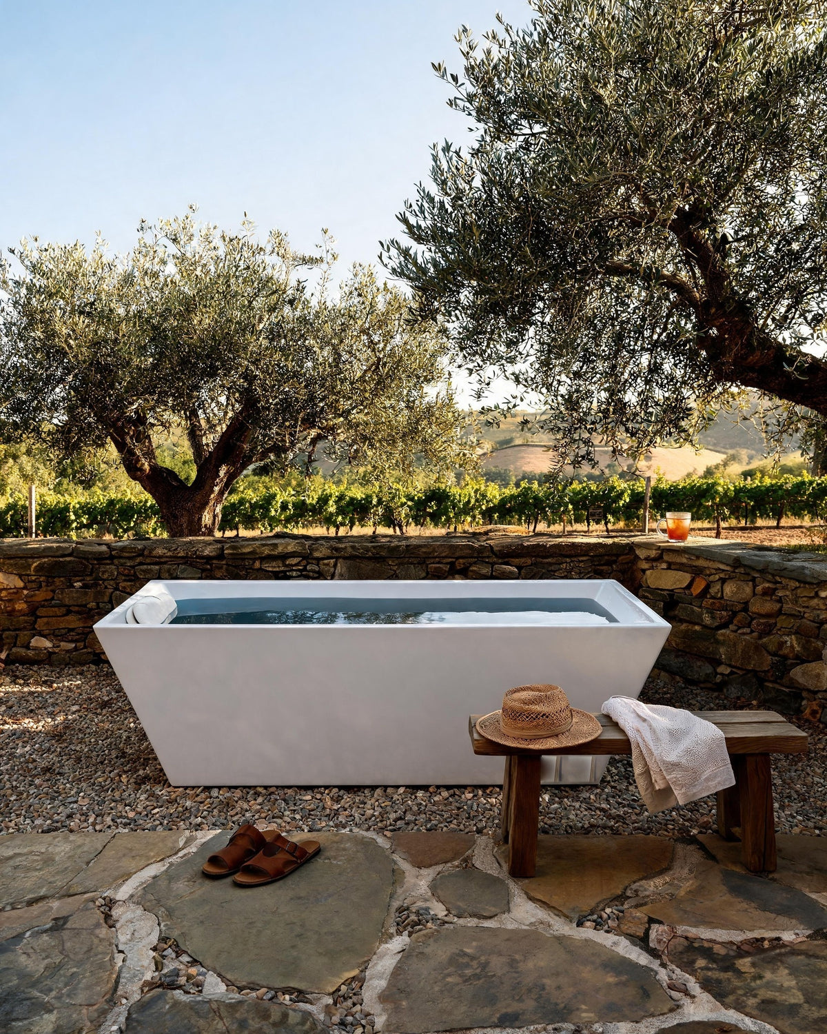 TIDE vessel filled with cold water in a stone courtyard among olive trees and vineyards in Napa Valley