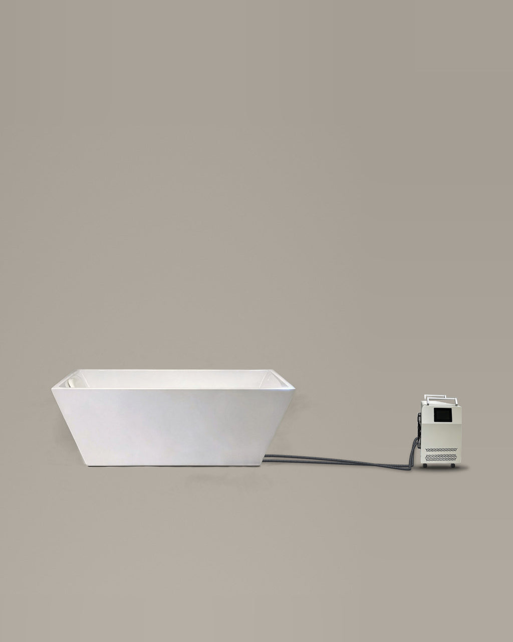 White flared rectangular bathing vessel on a warm grey studio backdrop beside its Hot & Cold Unit, connected by two braided hoses